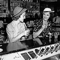 1930s two women drinking sodas eating ice cream at soda shop counter