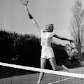 1950s Woman Jumping To Hit Tennis Ball